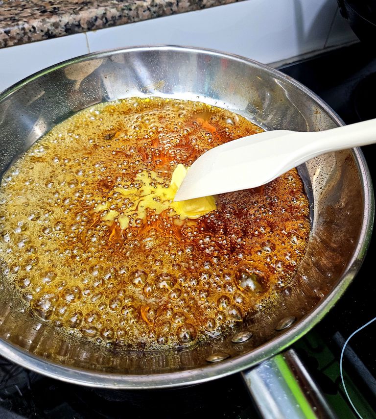 Stirring butter into caramel