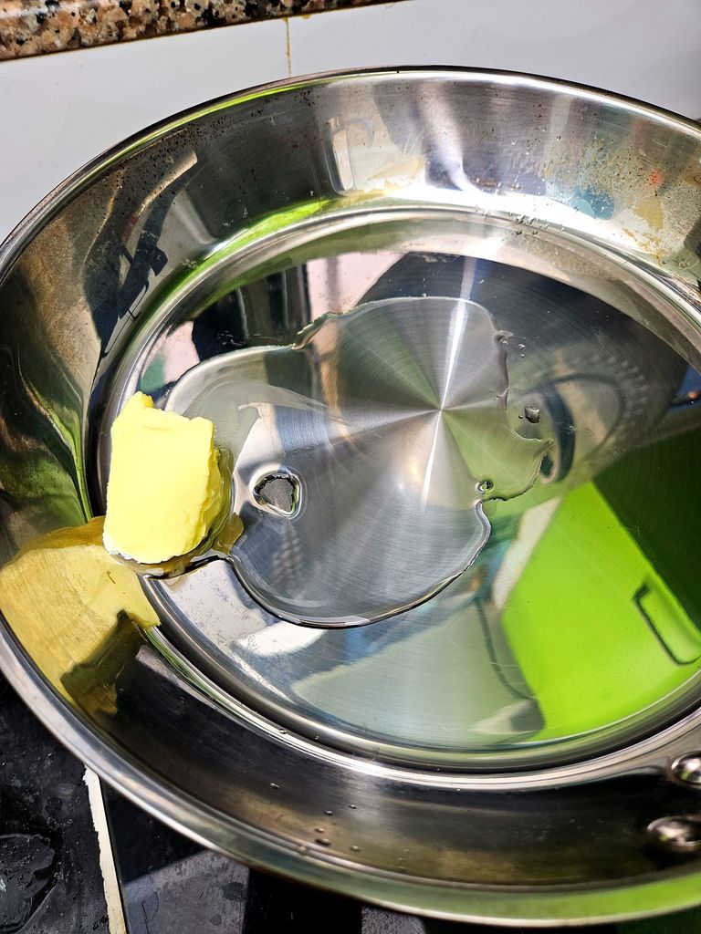 Putting oil and butter into the pot