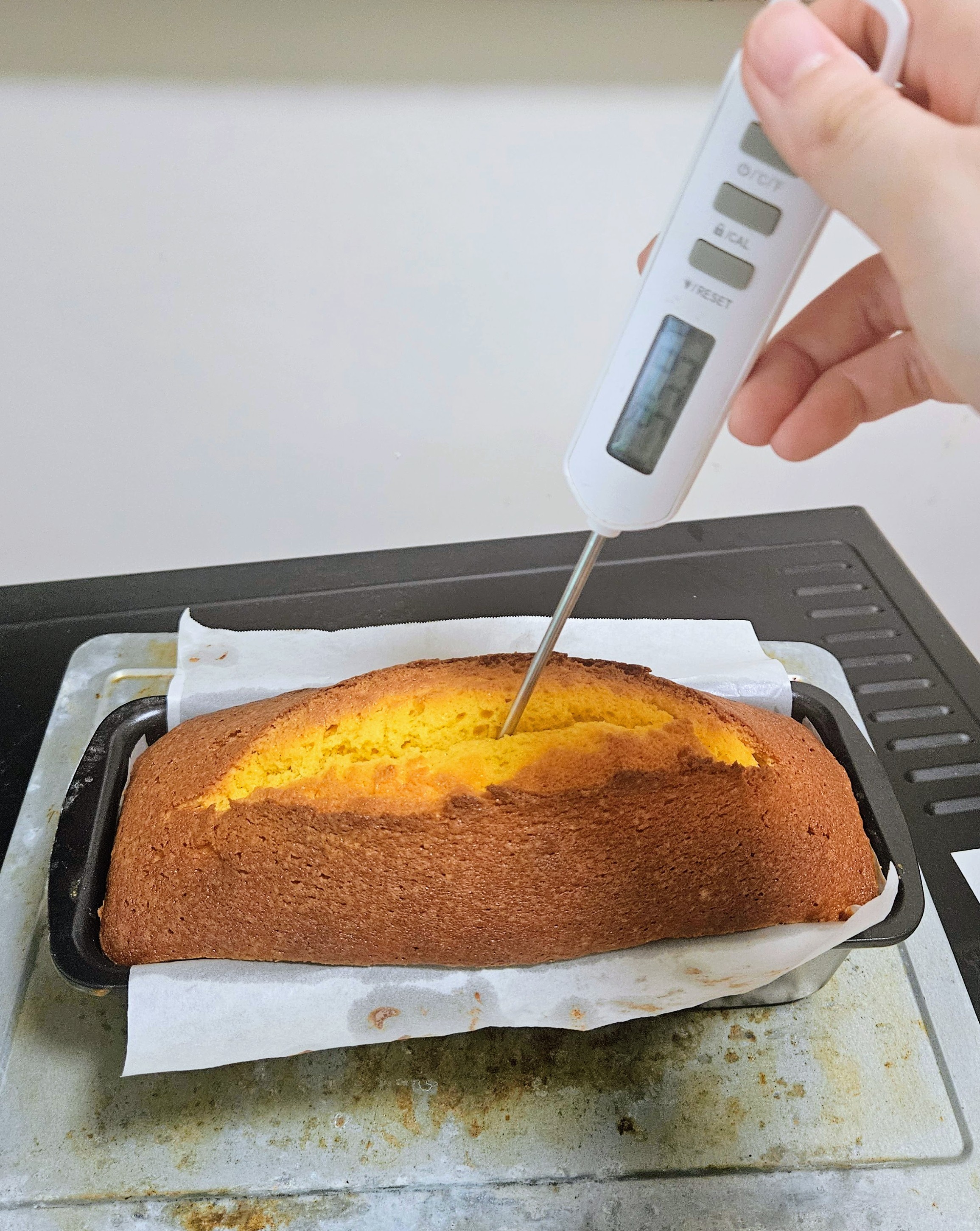 Sticking thermometer into the cake